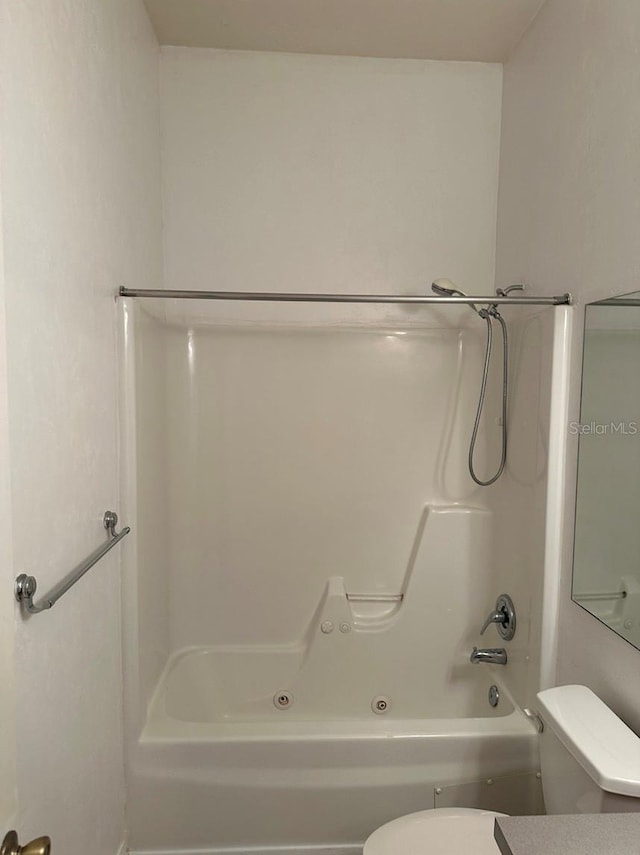 bathroom with toilet and tub / shower combination