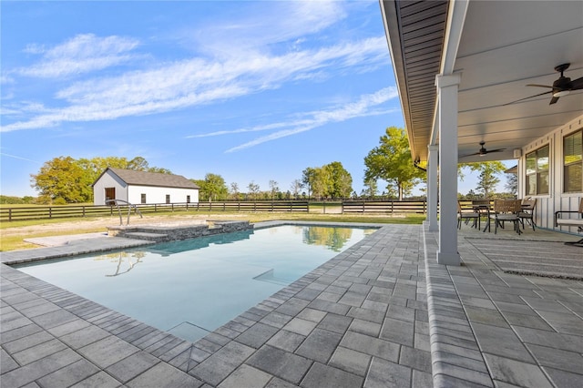 view of swimming pool with a patio and ceiling fan