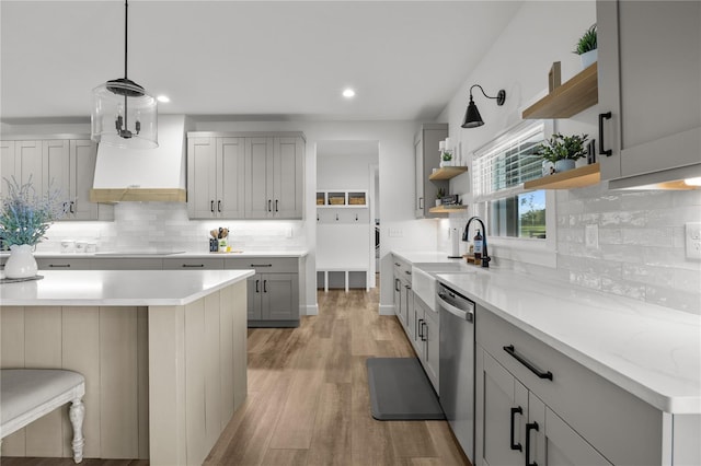 kitchen with gray cabinetry, black electric cooktop, sink, dishwasher, and hanging light fixtures