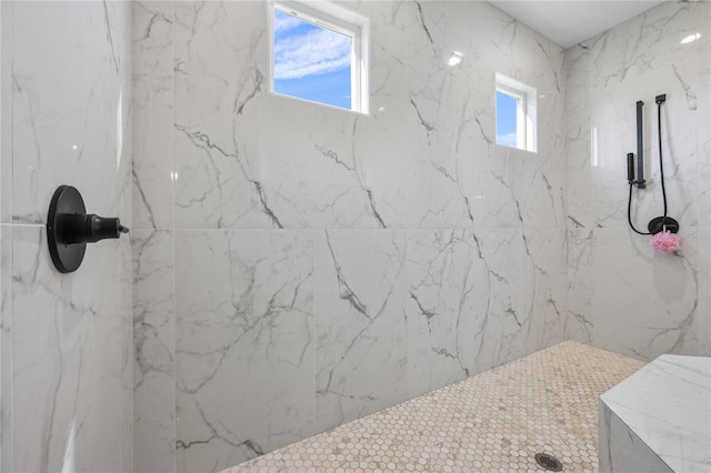 bathroom with tiled shower