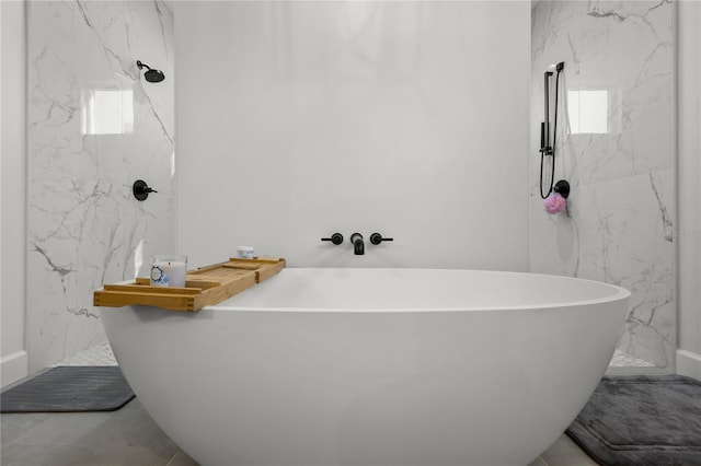 bathroom featuring a washtub and tile patterned flooring