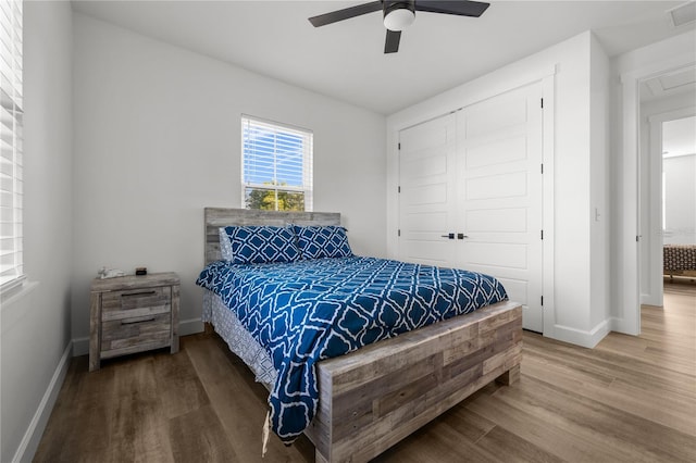 bedroom featuring ceiling fan, a closet, and hardwood / wood-style floors