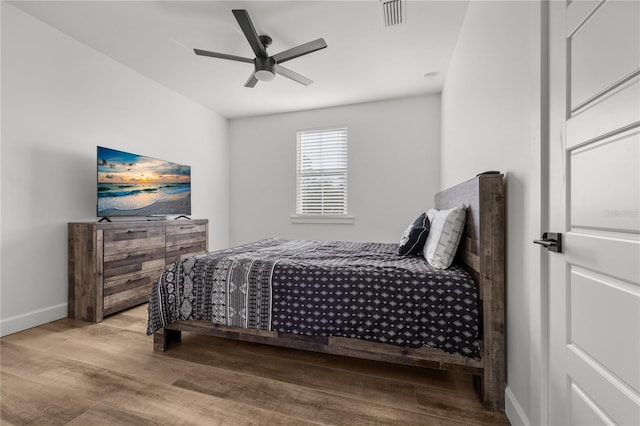 bedroom with ceiling fan and light hardwood / wood-style floors