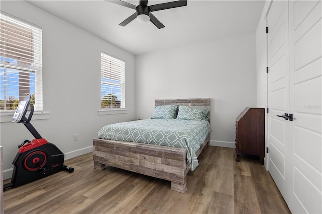 bedroom with wood-type flooring and ceiling fan