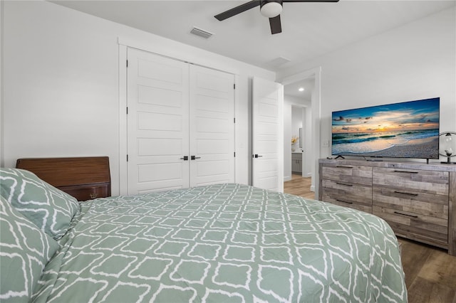 bedroom with hardwood / wood-style floors, ceiling fan, and a closet