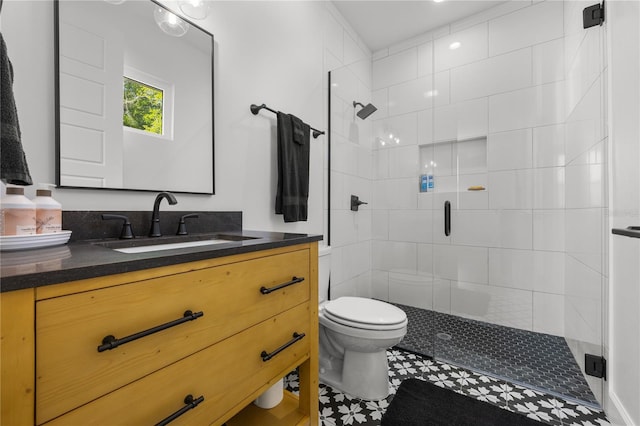 bathroom with tile patterned floors, vanity, toilet, and walk in shower