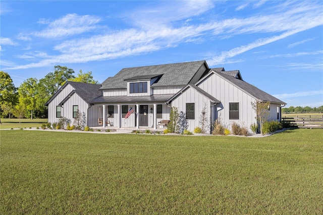 modern farmhouse featuring a front lawn and a porch