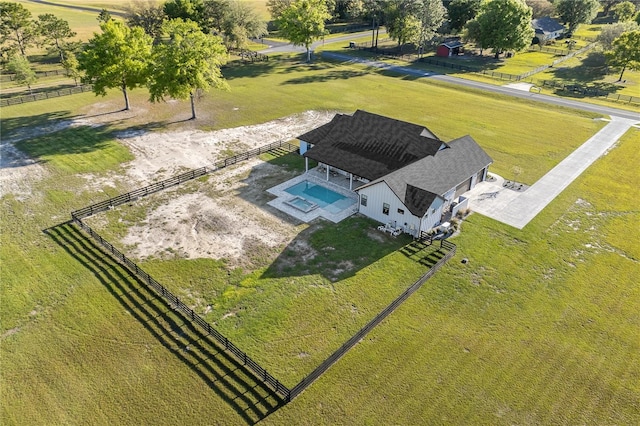 birds eye view of property with a rural view