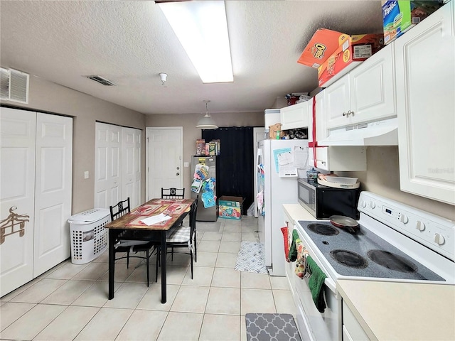 kitchen featuring stainless steel appliances, white cabinetry, hanging light fixtures, and light tile patterned floors