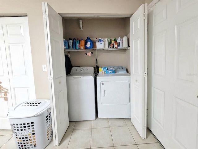 washroom with light tile patterned flooring and separate washer and dryer