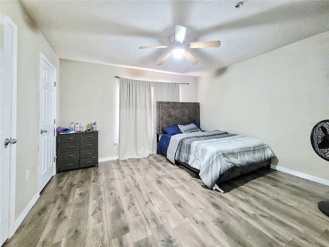 bedroom featuring light hardwood / wood-style floors and ceiling fan