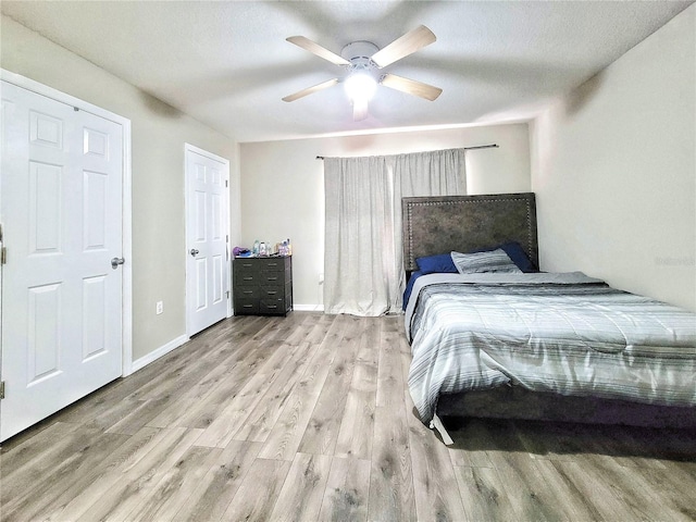 bedroom with ceiling fan and light hardwood / wood-style flooring