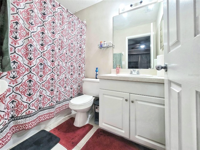 bathroom with vanity, tile patterned floors, and toilet