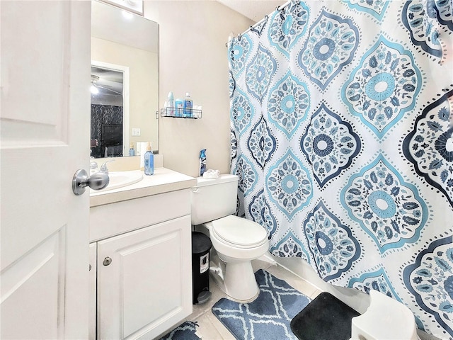 bathroom featuring tile patterned flooring, vanity, and toilet