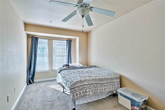 bedroom with light carpet, ceiling fan, and a textured ceiling