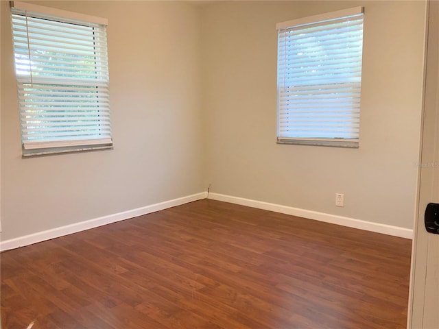 spare room with dark hardwood / wood-style floors