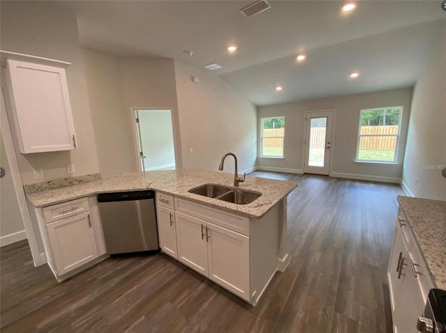 kitchen with light stone countertops, stainless steel dishwasher, white cabinetry, and sink