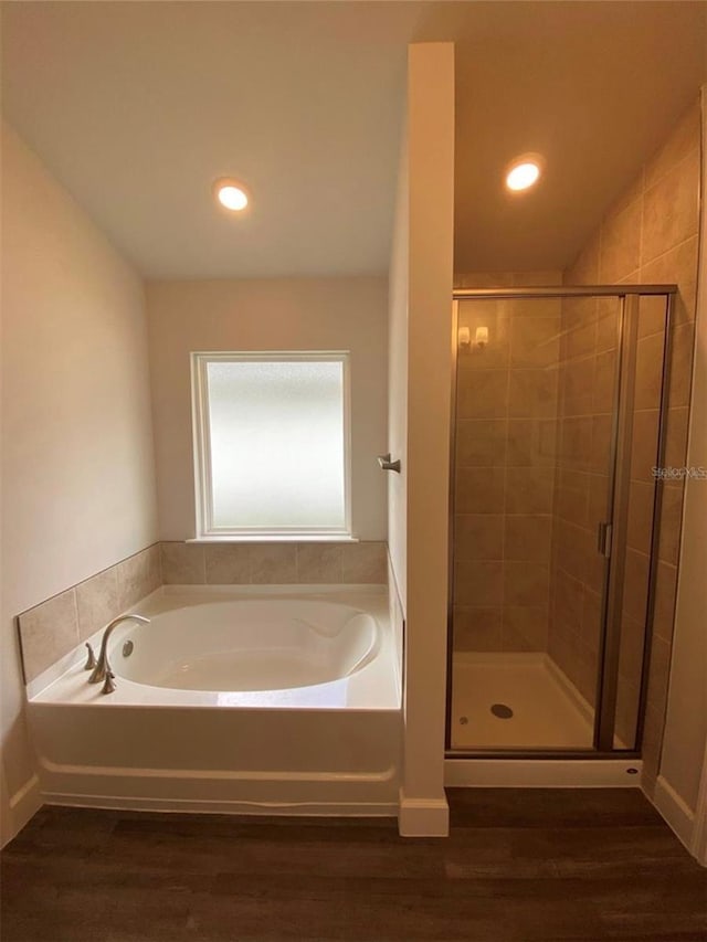 bathroom with plus walk in shower and hardwood / wood-style flooring