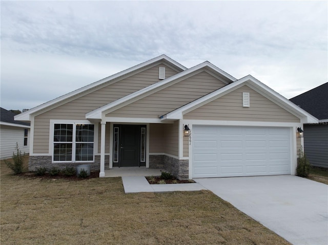 craftsman inspired home with a garage and a front lawn