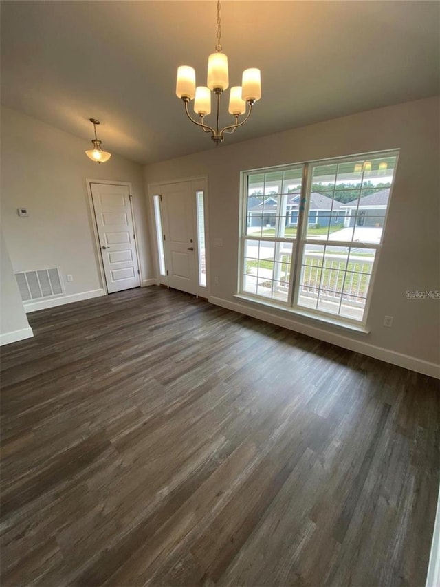 interior space featuring vaulted ceiling, a notable chandelier, and dark hardwood / wood-style floors