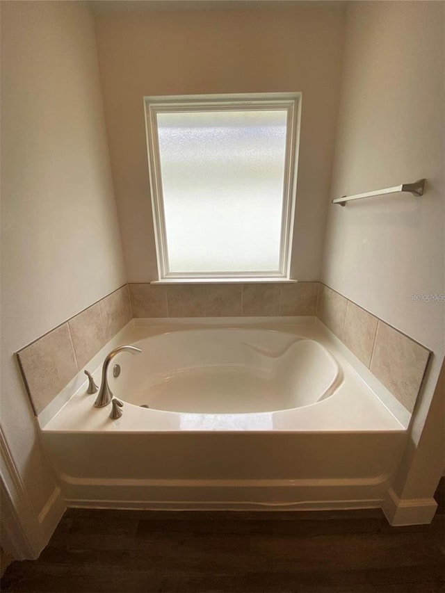 bathroom featuring a washtub and hardwood / wood-style floors