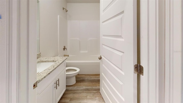 full bathroom featuring toilet, vanity, hardwood / wood-style flooring, and  shower combination