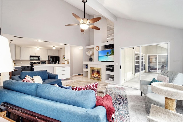 living room with ceiling fan, a tiled fireplace, built in features, and high vaulted ceiling