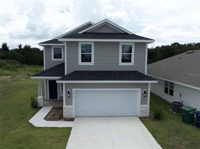 view of front of home featuring a garage, a front yard, and central AC