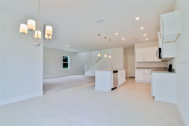 kitchen with decorative light fixtures, white cabinetry, stainless steel appliances, a notable chandelier, and a center island with sink