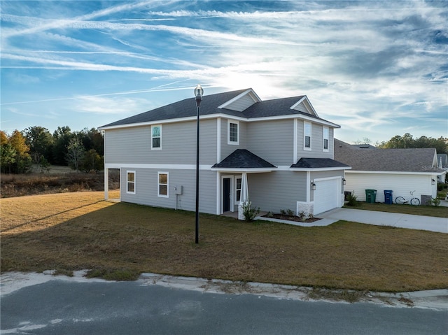 front of property featuring a front lawn and a garage