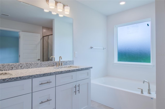 bathroom with shower with separate bathtub and vanity