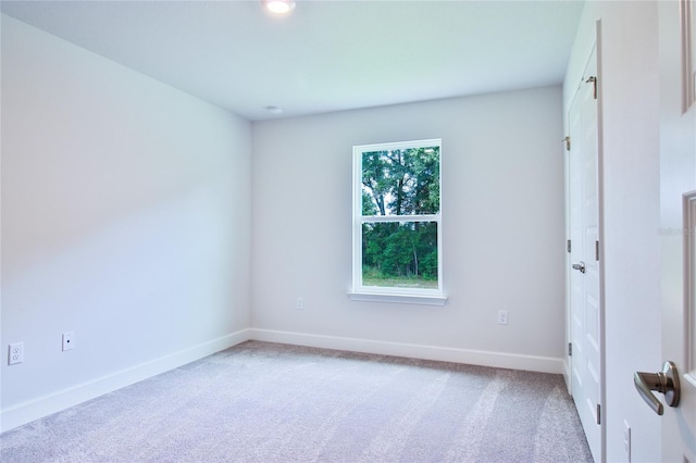 carpeted empty room featuring plenty of natural light