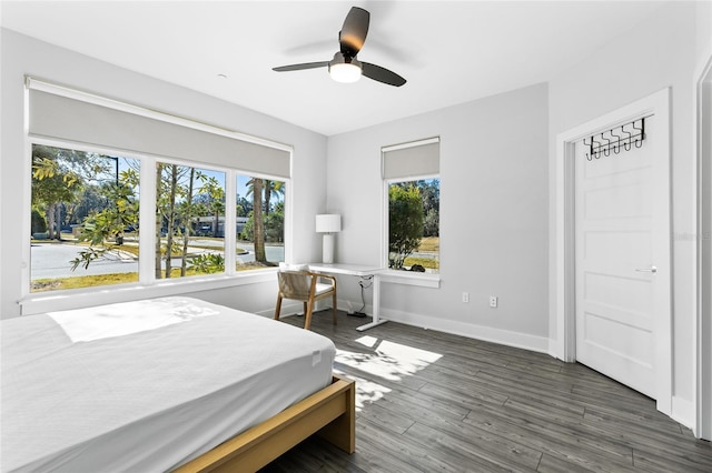 bedroom with ceiling fan and dark hardwood / wood-style floors