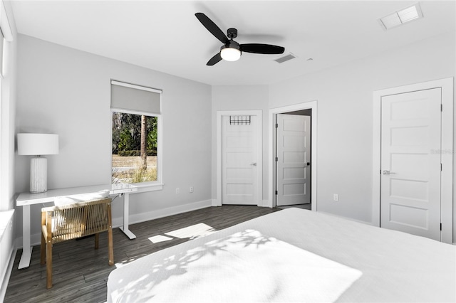 bedroom with dark hardwood / wood-style floors and ceiling fan