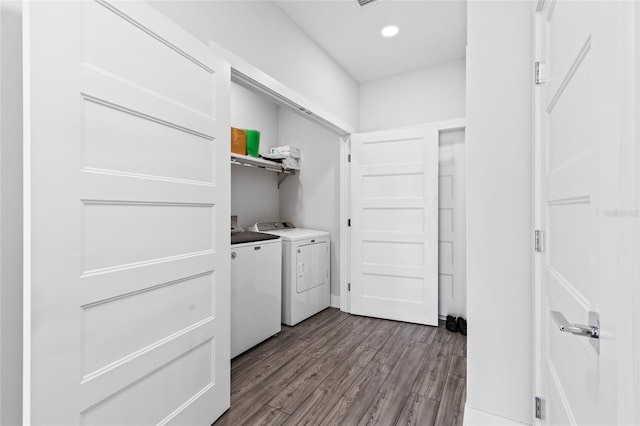 laundry room with washing machine and dryer and light hardwood / wood-style flooring