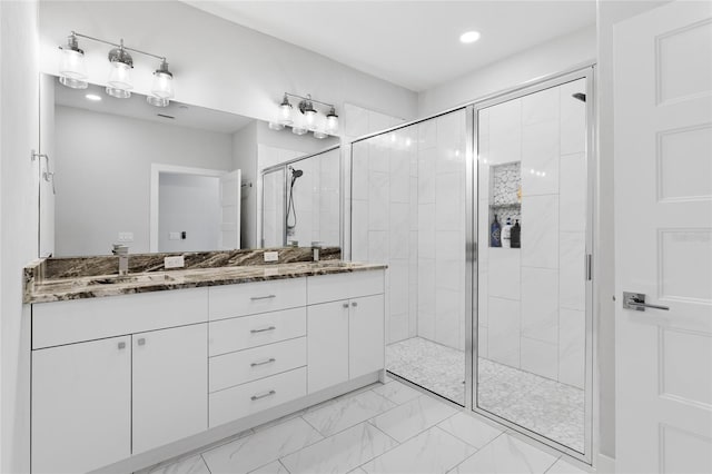 bathroom with vanity and a shower with shower door