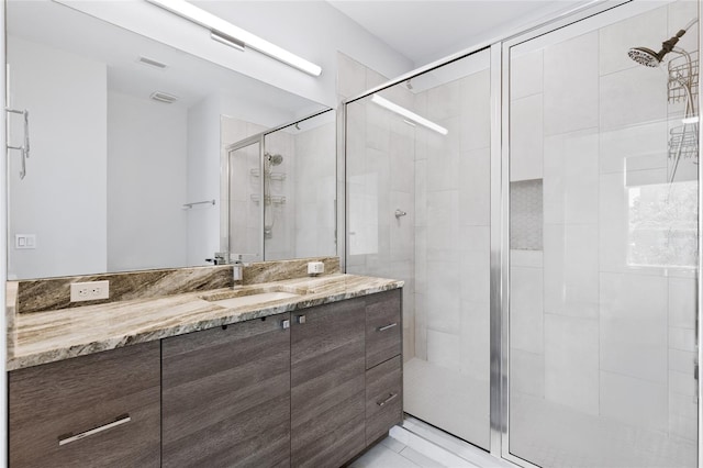 bathroom featuring vanity and an enclosed shower