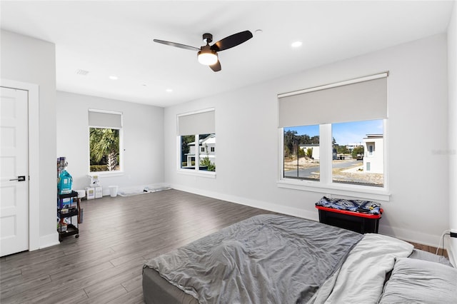 bedroom with ceiling fan and dark hardwood / wood-style flooring