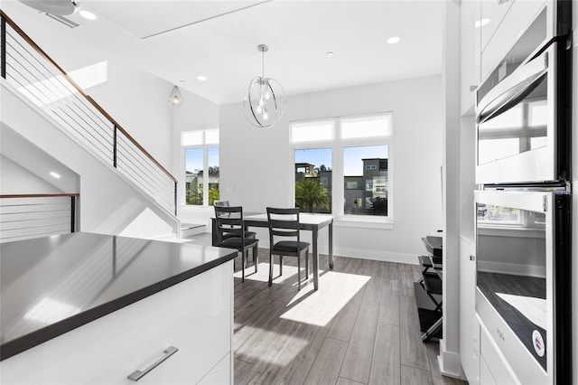 dining area featuring dark hardwood / wood-style floors and a notable chandelier