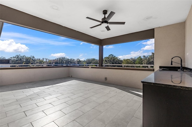 view of patio with ceiling fan and sink