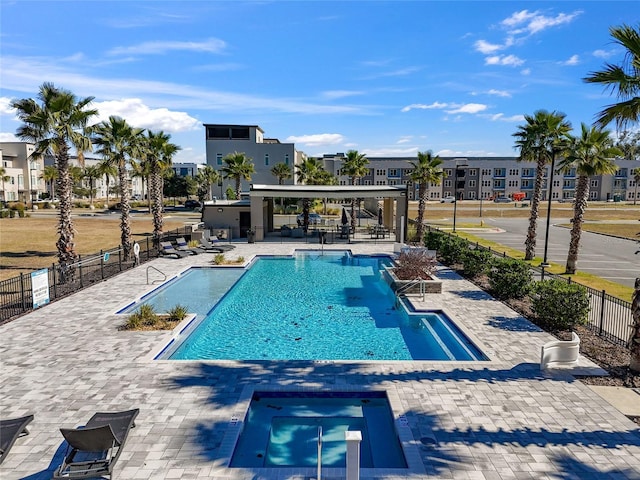 view of swimming pool with a community hot tub and a patio