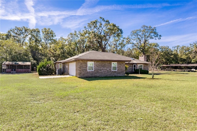 view of side of property with a lawn and a garage