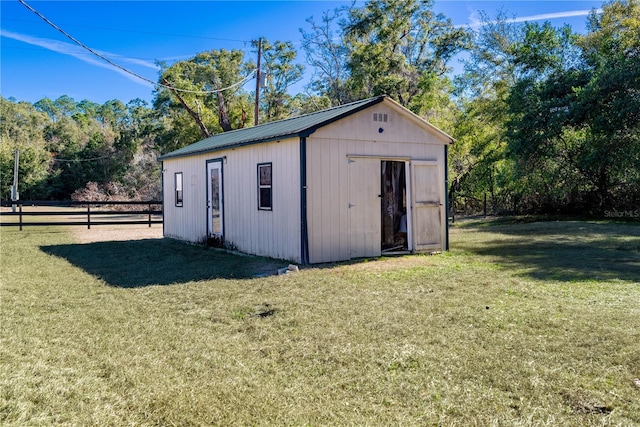 view of outbuilding with a yard