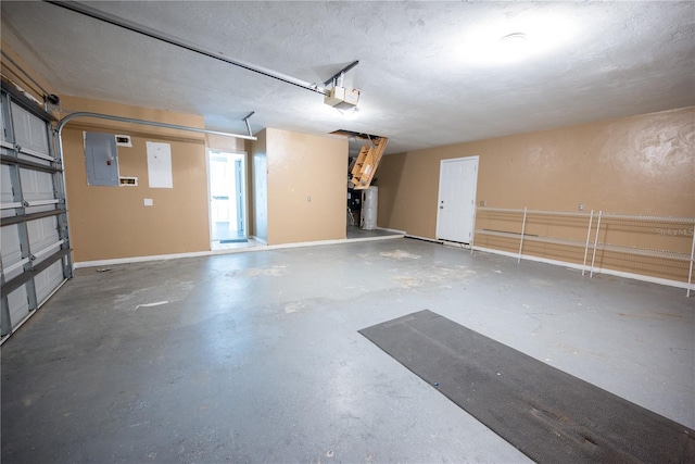 garage with electric panel and a garage door opener