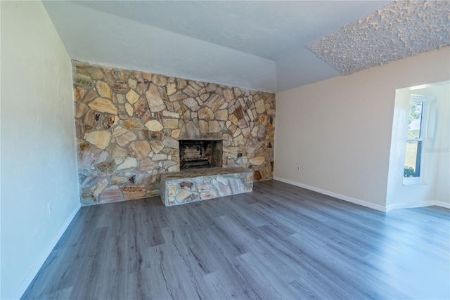 unfurnished living room featuring a fireplace and wood-type flooring