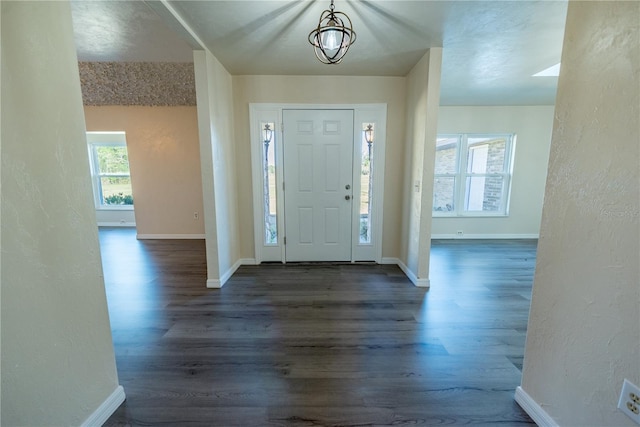 foyer featuring a chandelier and dark hardwood / wood-style flooring