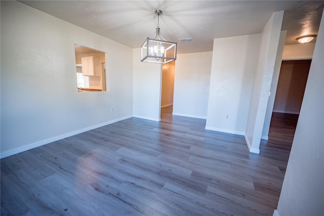 unfurnished dining area featuring wood-type flooring and a chandelier