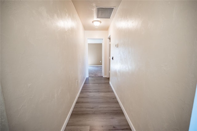 hallway with wood-type flooring