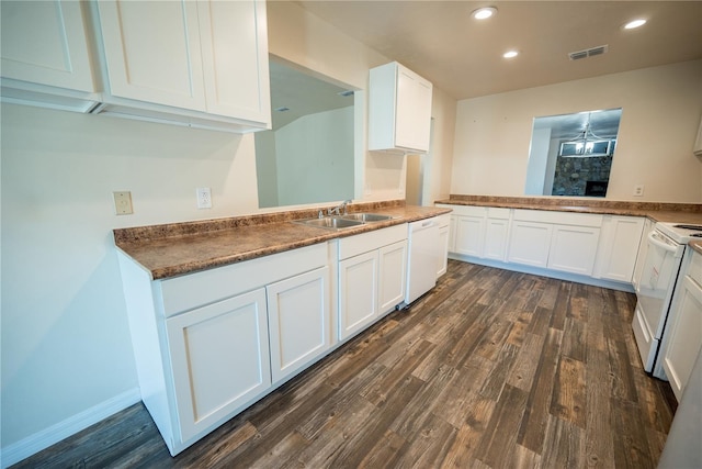 kitchen featuring white appliances, kitchen peninsula, sink, dark hardwood / wood-style floors, and white cabinetry