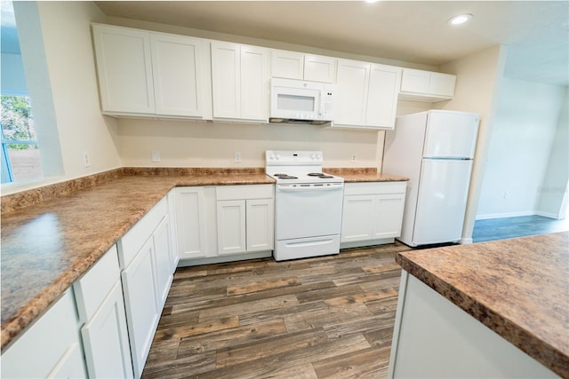 kitchen featuring white cabinets, dark hardwood / wood-style flooring, and white appliances